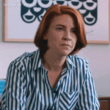 a woman with red hair is wearing a blue and white striped shirt with the words workin moms below her