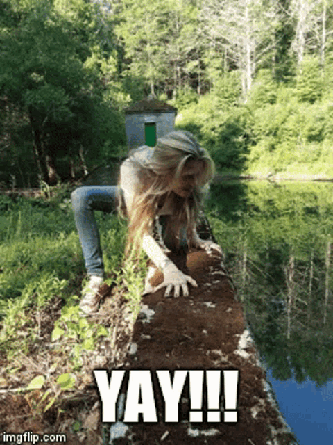 a woman is crawling on a rock near a body of water with the caption yay !!