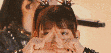a girl making a heart shape with her hands