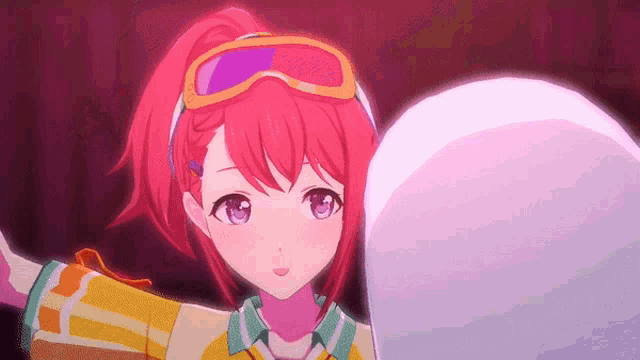 a girl with red hair and purple eyes is wearing goggles and holding a snowball .