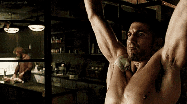 a shirtless man is hanging upside down with his arms outstretched in front of a window that says coperoflight tumblr