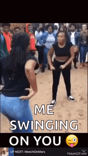 two women are dancing in front of a crowd with the words `` me swinging on you '' written on the bottom .