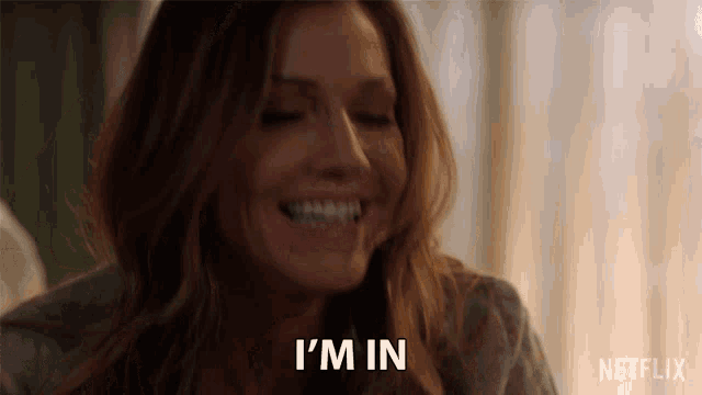 a woman is smiling and says i 'm in in a netflix ad