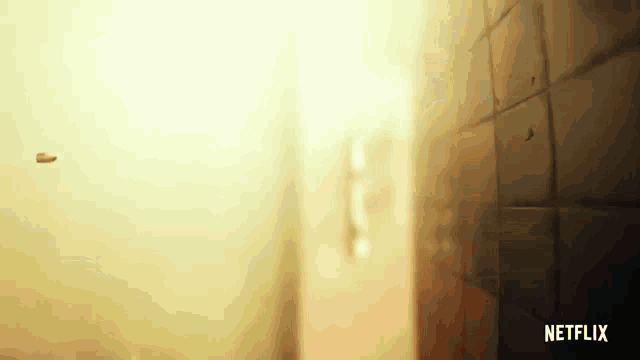 a bullet is flying through the air in a room with a netflix logo in the corner .