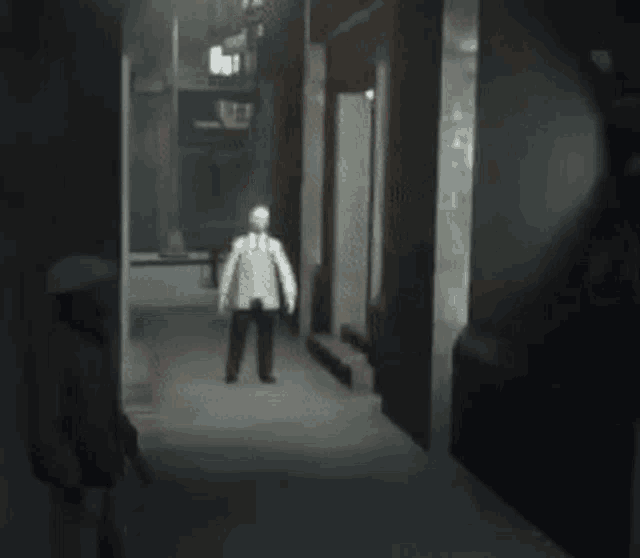 a blurred image of a man standing in a dark hallway