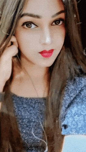 a close up of a woman 's face with long hair and red lips