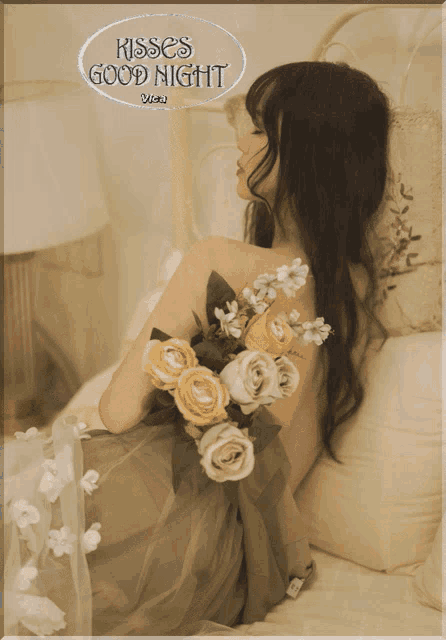 a woman laying on a bed with a bouquet of flowers and the words kisses good night written above her