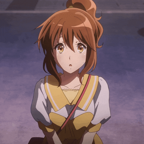 a girl with brown hair is wearing a yellow top
