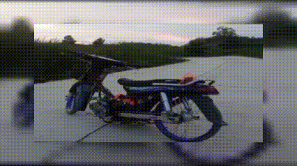 a motorcycle is parked on the side of a road in a picture frame .