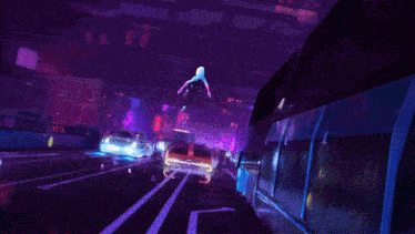 a spider-man character is flying through the air in a city at night