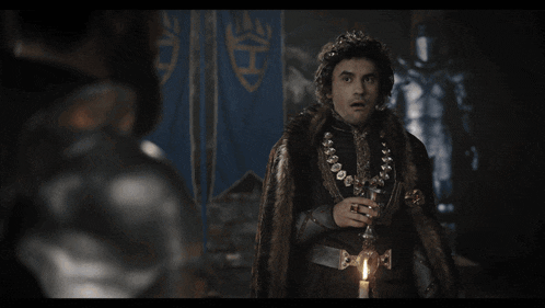 a man in a fur coat with a crown on his head and the words bugun de baskasi adina utandk below him