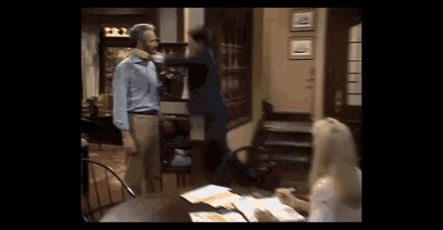 a man is standing next to a woman in a living room .