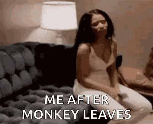 a woman is sitting on a couch with the words `` me after monkey leaves '' written on her face .