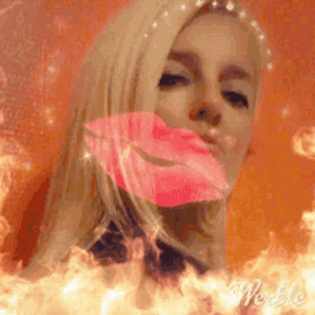 a woman is blowing a kiss with a fire background