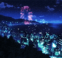 a city at night with fireworks going off in the sky