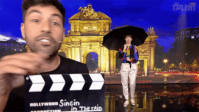a man holding a clapper board with the words hollywood singing in the rain on it