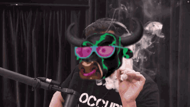 a man wearing a mask and sunglasses is smoking a cigar