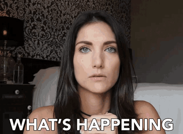 a woman in a bedroom with the words what 's happening behind her