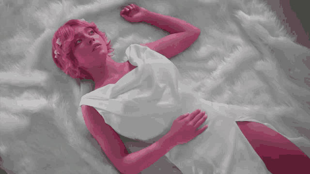 a woman in a white dress is laying on a bed with the words he has a girlfriend though