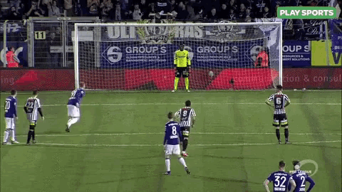 a soccer game is being played in front of a banner for play sports