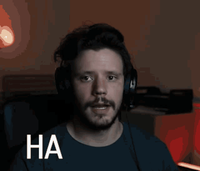 a man wearing headphones is laughing with the words ha ha ha written below him