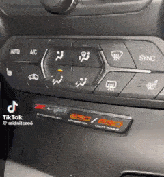 a close up of a car dashboard with a lot of buttons on it