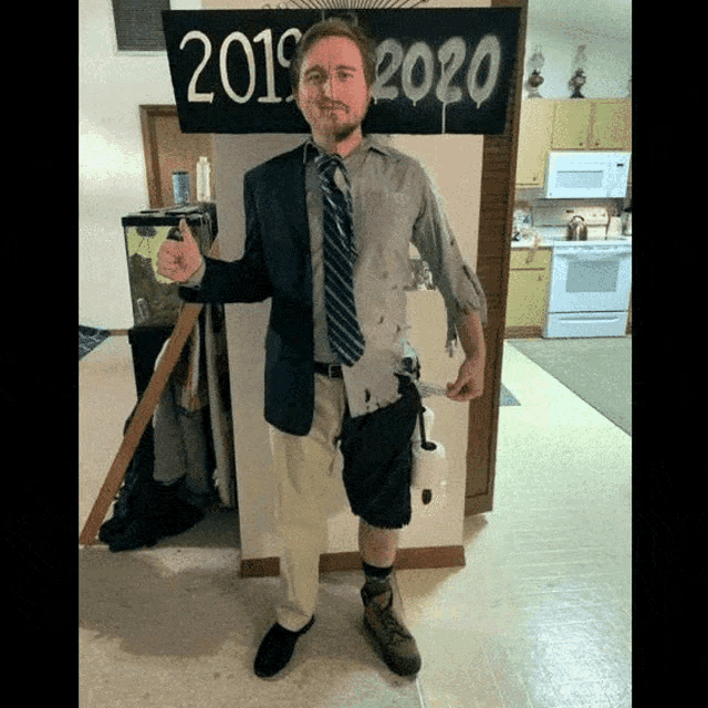 a man in a suit and tie stands in front of a sign that says 2019 2020