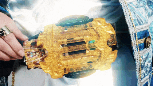 a person wearing a blue and white costume is holding a gold object