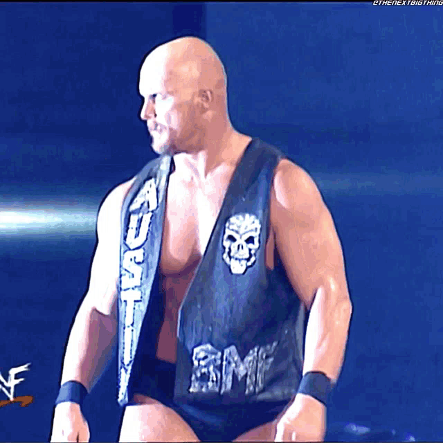 a wrestler wearing a black vest with the word smp on it