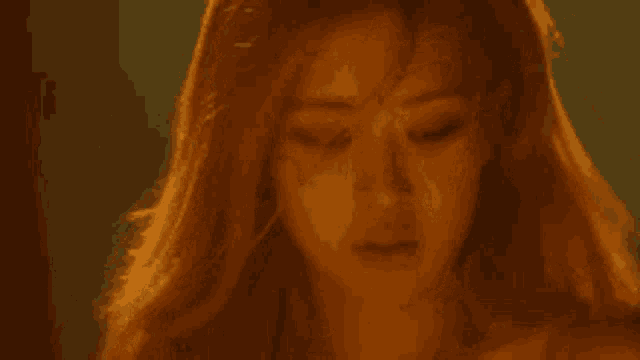 a close up of a woman 's face with long hair .
