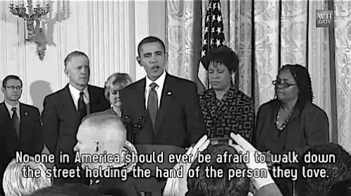 a group of people standing around a podium with the words " no one in america should ever be afraid to walk down the street "