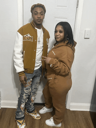 a man and a woman are standing next to each other and the man is wearing a jacket that says bernie place