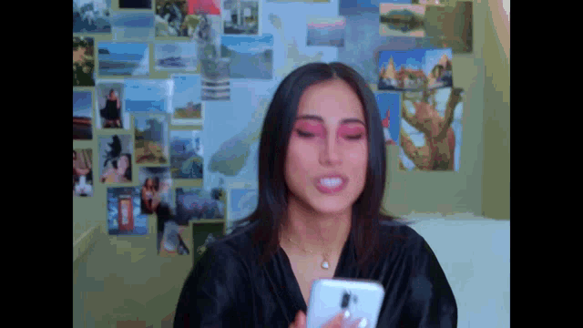 a woman in a black robe is looking at her phone