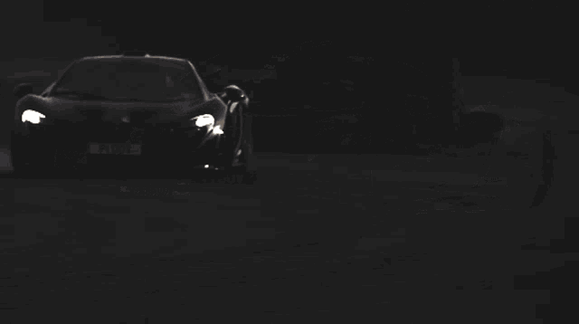 a black sports car with pi00v on the license plate