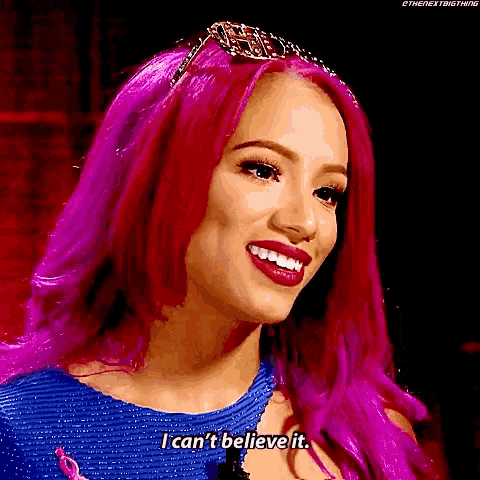 a woman with pink hair is smiling and saying `` i can 't believe it . ''