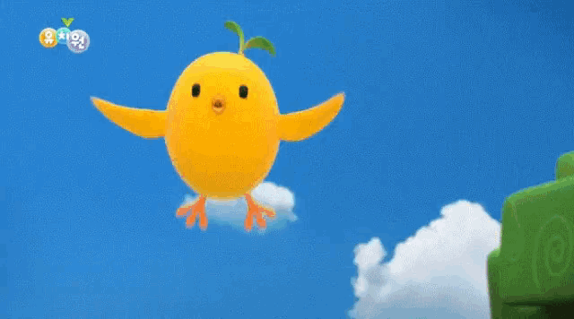 a yellow chicken is standing on top of a green ball with a blue sky in the background