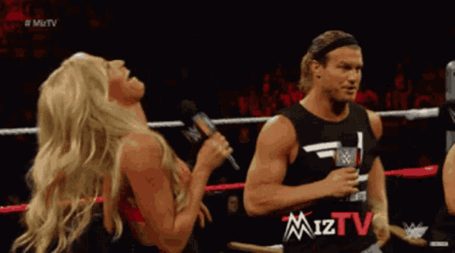 a man and a woman are in a wrestling ring with miztv written on the screen