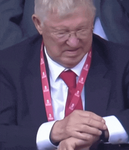 a man in a suit and tie with a lanyard that says emirates