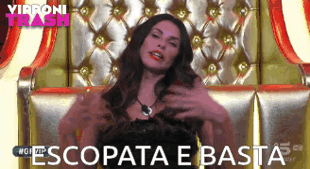 a woman is sitting in a chair with the words escopata e basta written on it