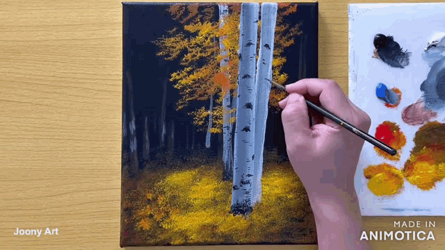 a person is painting a tree with yellow leaves on a canvas made in animatica