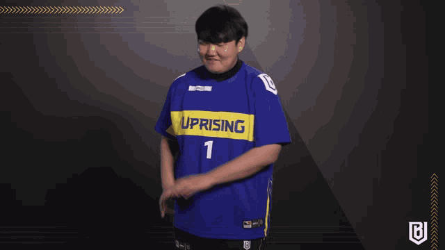a man wearing a blue and yellow jersey that says ' uprising ' on it