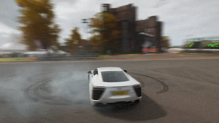 a white car with a license plate that says ' lx ' on it is drifting on a road