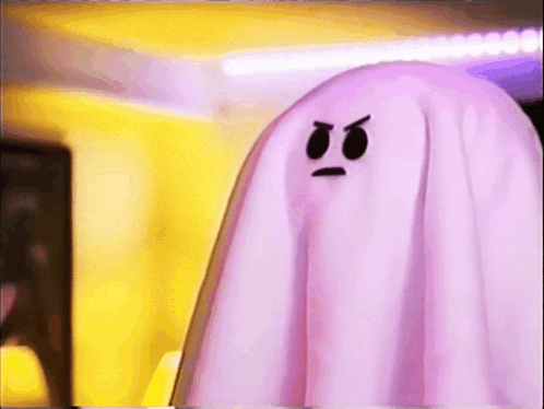 two pink ghosts with angry faces on them are standing next to each other in a room .