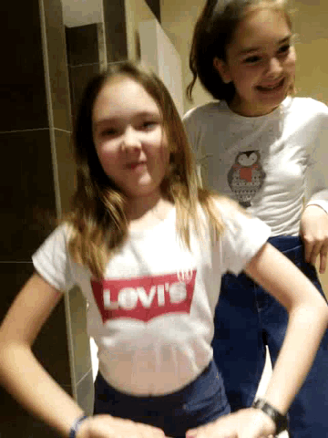 a girl wearing a levi 's shirt is laying down