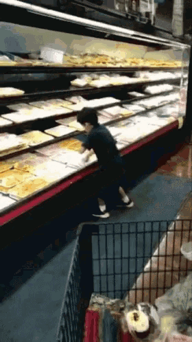 a person standing in front of a display of food