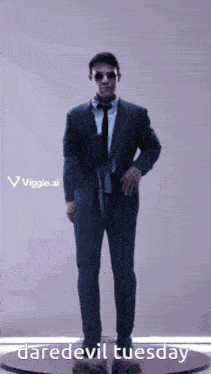 a man in a suit and tie is standing on a pedestal with the words daredevil tuesday written below him
