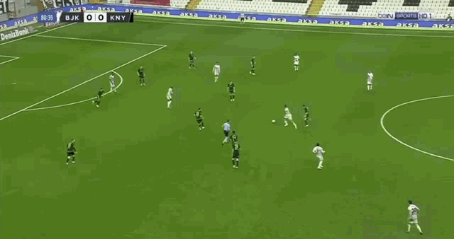 a soccer game is being played on a field with advertisements for acibadem