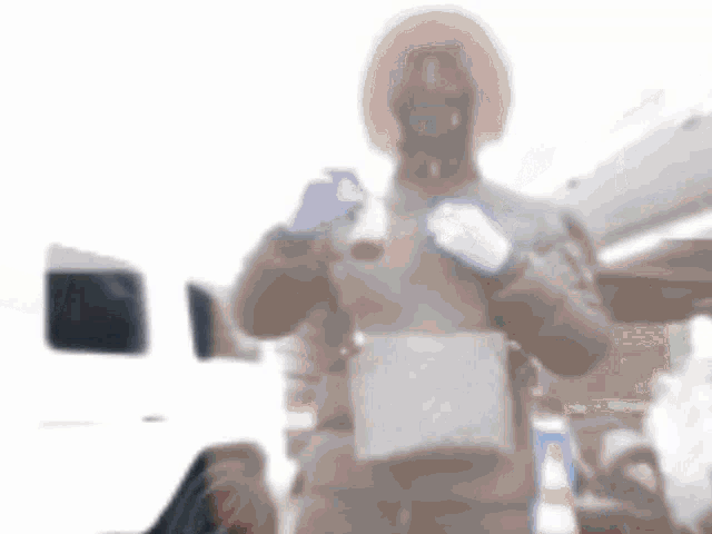 a blurred image of a man wearing a mask and gloves