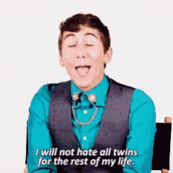 a young man in a blue shirt and vest is saying i will not hate all twins for the rest of my life ..