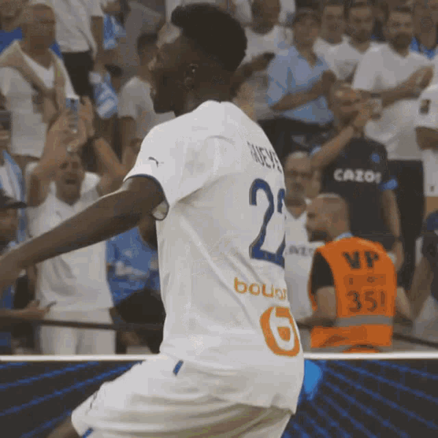 a soccer player wearing a white jersey with the number 24 on it